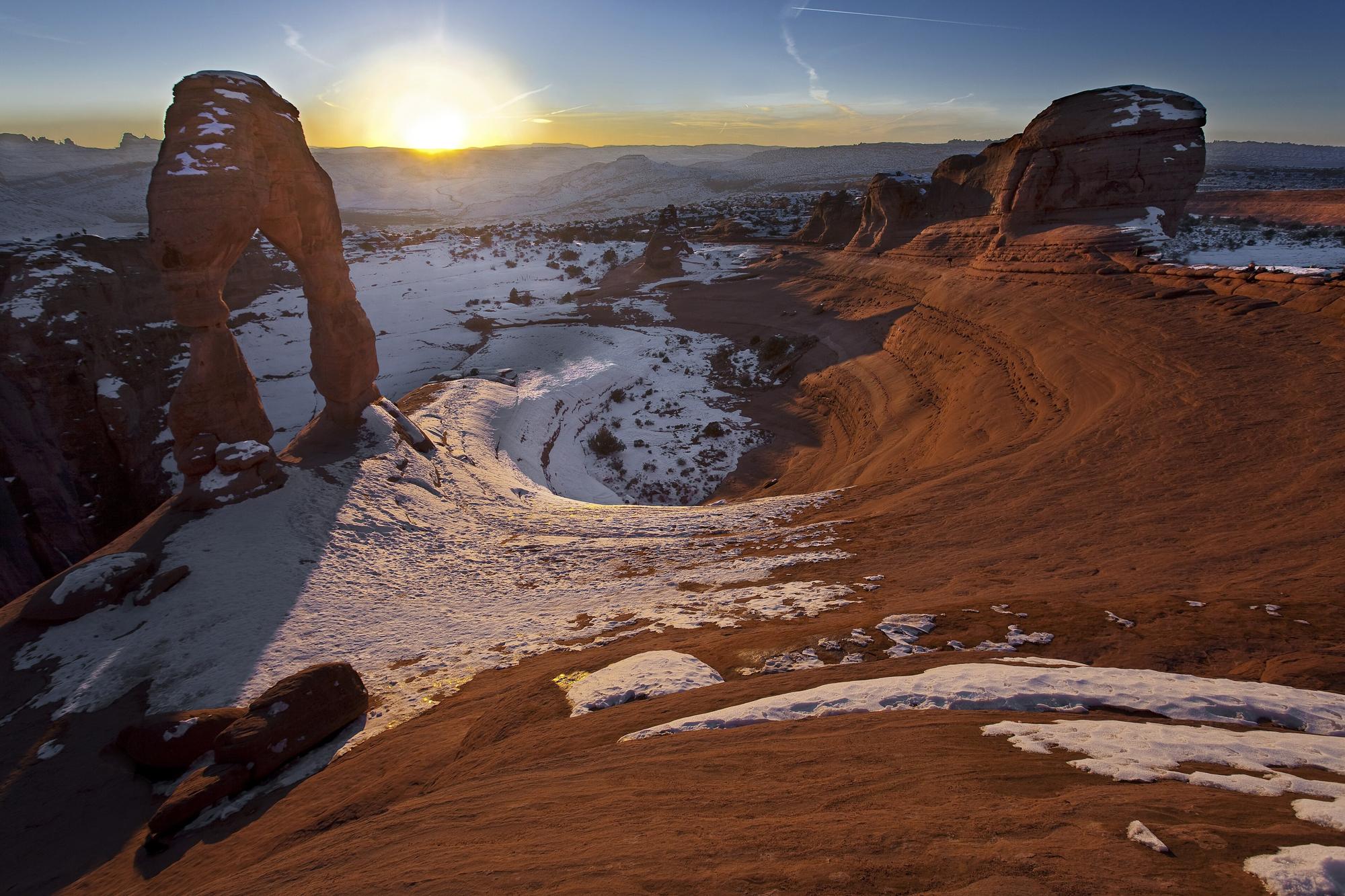 Delicate Arch at sunset with snow on the slickrock, Arches National Park