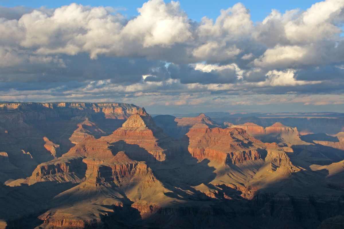Late light on the buttes and side canyons of the Grand Canyon from Grandview Point, with white clouds above