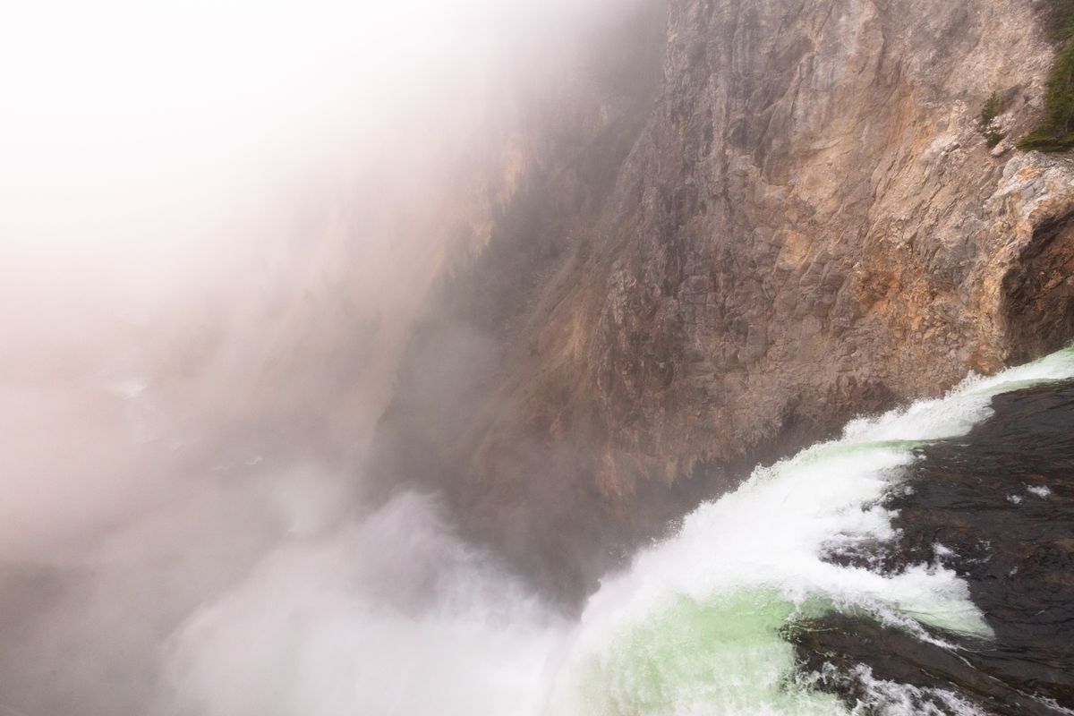 Mist rising from the Lower Falls of the Yellowstone into the yellow walls of the Grand Canyon of the Yellowstone